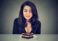 Desperate woman craving cake dessert, eager to eat Royalty Free Stock Photo