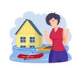 Desperate woman standing in front of flooded house