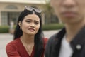 A desperate young asian woman pleads to her boyfriend to listen to her, or not abandon the relationship Royalty Free Stock Photo