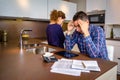 Desperate young couple with debts reviewing their Royalty Free Stock Photo