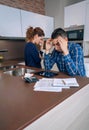 Desperate young couple with debts reviewing their Royalty Free Stock Photo