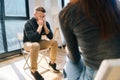 Desperate young man sharing problem sitting in circle during group interpersonal therapy session. Royalty Free Stock Photo