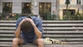 Desperate young man sitting alone on bench, suffering depression after break-up Royalty Free Stock Photo