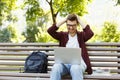 Desperate young man using laptop outdoors Royalty Free Stock Photo