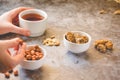 Dessert bars made of sunflower seeds  in a honey caramel. Gozinak, Caramelized peanuts in white bowl and on gray background..The Royalty Free Stock Photo