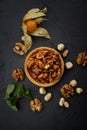 Dessert basket with nuts and caramel, on a black stone