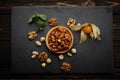 Dessert basket with nuts and caramel, on a black stone