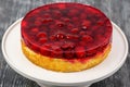 Dessert biscuit cake with cream and cherries in jelly