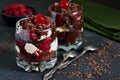 Dessert black forest in a glass. Chocolate dessert with creamy cream, cherry and chocolate on a concrete background. The