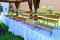 Dessert buffet line on white tables in the garden Royalty Free Stock Photo