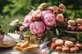 Dessert buffet with peony flowers, catering for wedding, party and holiday celebration, cakes and desserts in a countryside garden