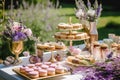 Dessert buffet table, food catering for wedding, party holiday celebration, lavender decor, cakes and desserts in a country garden