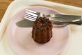 Dessert Canele on white plate at cafe ,Caneles de bordeaux