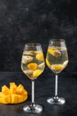 Dessert champagne jelly with exotic fruits - mango and pitahaya in a glass.