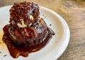 Dessert with chocolate brownie and vanilla ice cream, covered in hot chocolate sauce Royalty Free Stock Photo