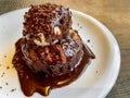 Dessert with chocolate brownie and vanilla ice cream, covered in hot chocolate sauce Royalty Free Stock Photo