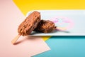 Dessert chocolate ice cream bars with nuts, wooden stick on blue and yellow pastel background. Eskimo in blue vintage Royalty Free Stock Photo
