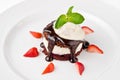 Dessert with chocolate sponge cake, vanilla cream, cherry, ice cream and strawberries Royalty Free Stock Photo