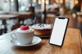 Dessert, coffee cup, and blank phone screen in a Valentine\'s cafe setting Royalty Free Stock Photo