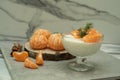 Dessert with cottage cheese and tangerines in a glass bowl