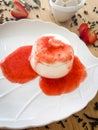 dessert dish, Panna cotta with strawberry sauce and strawberries on a wooden table