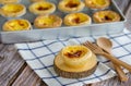 egg tart or Portugal egg tart sweet custard cream on wooden board with wooden spoon