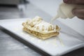 Dessert elaboration and plating on a restaurant kitchen.