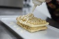 Dessert elaboration and plating on a restaurant kitchen.