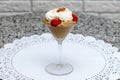 Dessert in a glass of chocolate mousse with whipped cream and strawberries on a white napkin Royalty Free Stock Photo