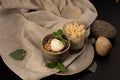 Dessert granola with a scoop of vanilla ice cream decorated with mint leaves.