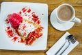 Dessert ice cream strawberry crepe and hot drink in coffee shop Royalty Free Stock Photo