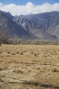 Barbed wire fence in front of blurred mountains Royalty Free Stock Photo