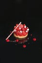 Dessert made from fresh strawberries, cream, cinnamon stick on a black plate. Royalty Free Stock Photo