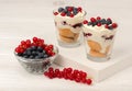 Dessert with mascarpone, cream, and berries in the glass cups on the wooden background. Royalty Free Stock Photo