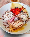 dessert: pancakes, strawberries, blueberries, ice cream and chocolate syrup Royalty Free Stock Photo