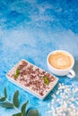 dessert, pastries italian dessert tiramissu sprinkled with chocolate with a cup of cappuccino on a blue background, top Royalty Free Stock Photo