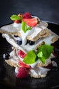 Dessert Pavlova with strawberry, raspberry, mint, bilberry on a grey background Royalty Free Stock Photo