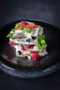 Dessert Pavlova with strawberry, raspberry, mint, bilberry on a grey plate and background Royalty Free Stock Photo