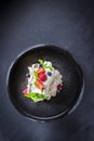 Dessert Pavlova with strawberry, raspberry, mint, bilberry on a grey plate and background. Top view Royalty Free Stock Photo