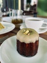 Dessert pistachio canele on a white plate