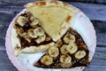 A dessert plate of A sweet baked pastry of chocolate pizza, Chakhtoura, sweet baked pastry baked in the oven, covered with