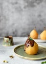 Dessert with poached golden pear, poured melted chocolate Royalty Free Stock Photo