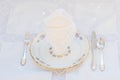 Dessert set: porcelain plates with silver cutery and lace napkin