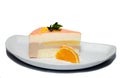 Dessert with souffle, decorated with orange and washed, on a white plate. White background
