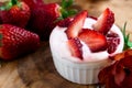 Dessert of soy yogurt and oatmeal, strawberry juice and fresh strawberries on a wooden tray,