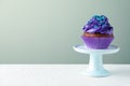 Dessert stand with tasty cupcake on white table