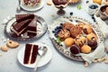 Dessert table with all kinds snacks on light background