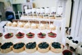 Dessert table at a party or wedding ceremony with delicious sweet cakes with strawberries and cream Royalty Free Stock Photo