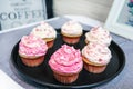 Dessert Valentine vanilla cupcakes with pink and white cream decorated with sweet hearts