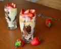 Dessert vanilla mousse with chocolate, strawberries and cookies in glass